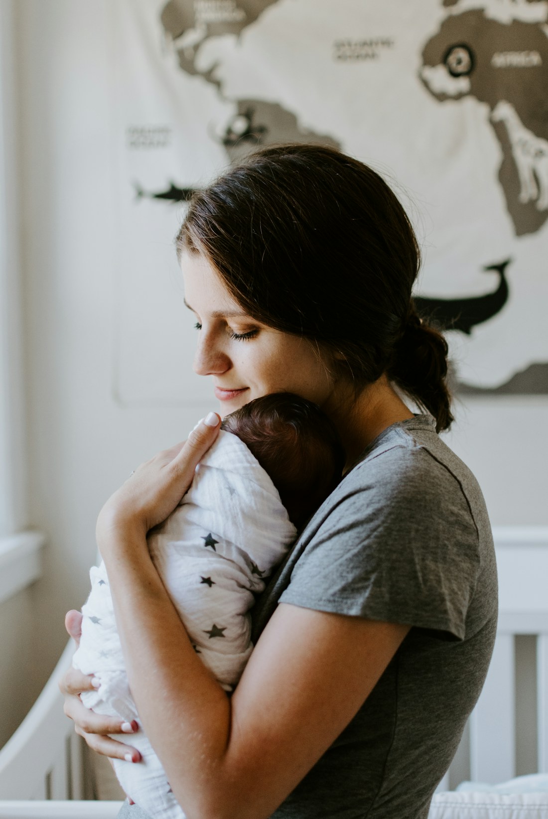 A parent cradling their sleeping baby